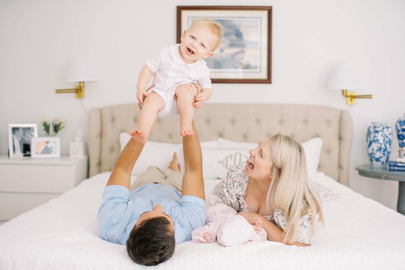 family portrait on bed with dad holding toddler in the air by Elizabeth Tate Photography 17