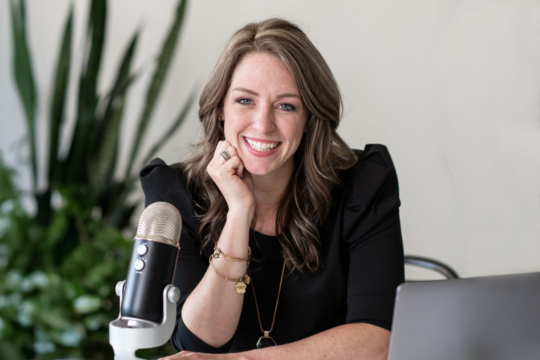 portrait of Rachel Brenke The LawTog at her desk with microphone and laptop